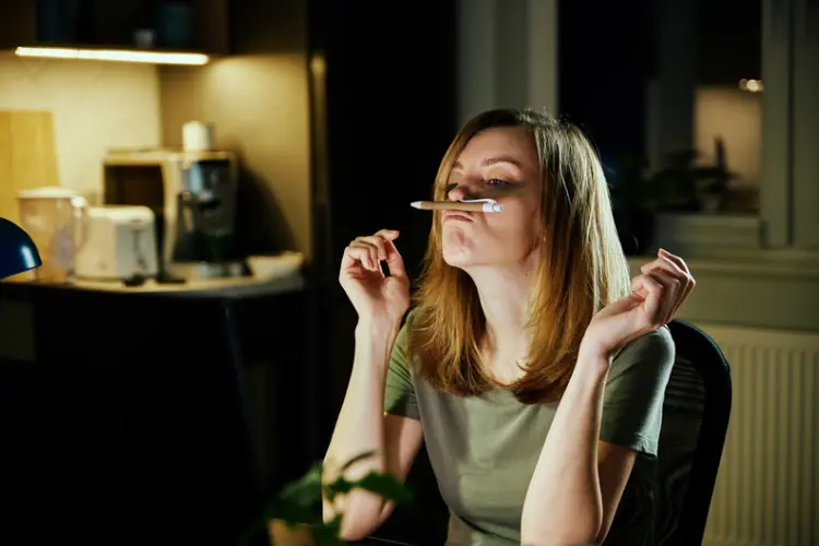 woman with pen on top lip