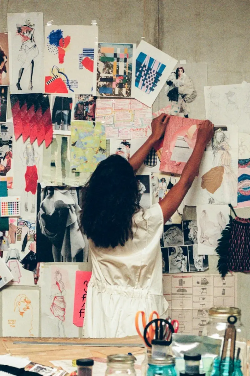 person putting images on to a wall